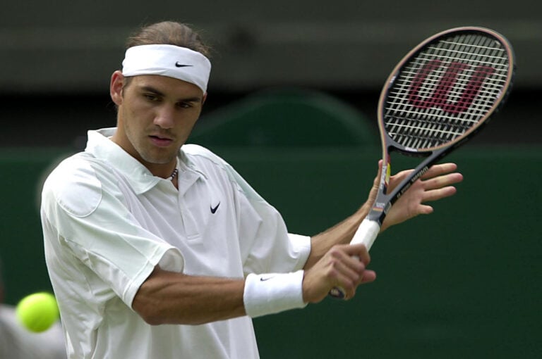 4 Jul 2001:  Roger Federer of Switzerland in action against Tim Henman of Great Britain during the men's quarter finals of The All England Lawn Ten...