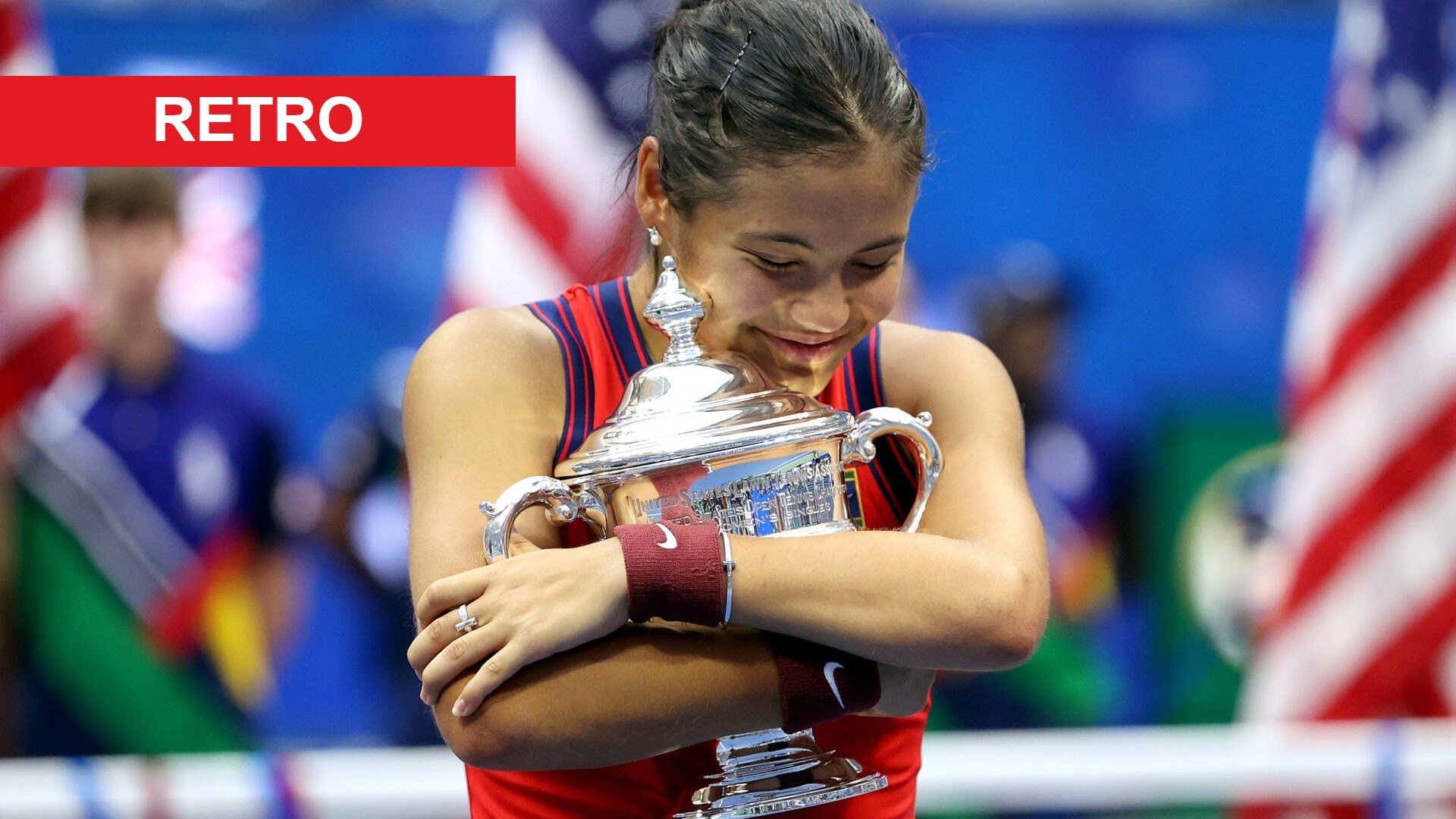 Image of Emma Raducanu celebrating with the trophy after winning the 2021 US Open