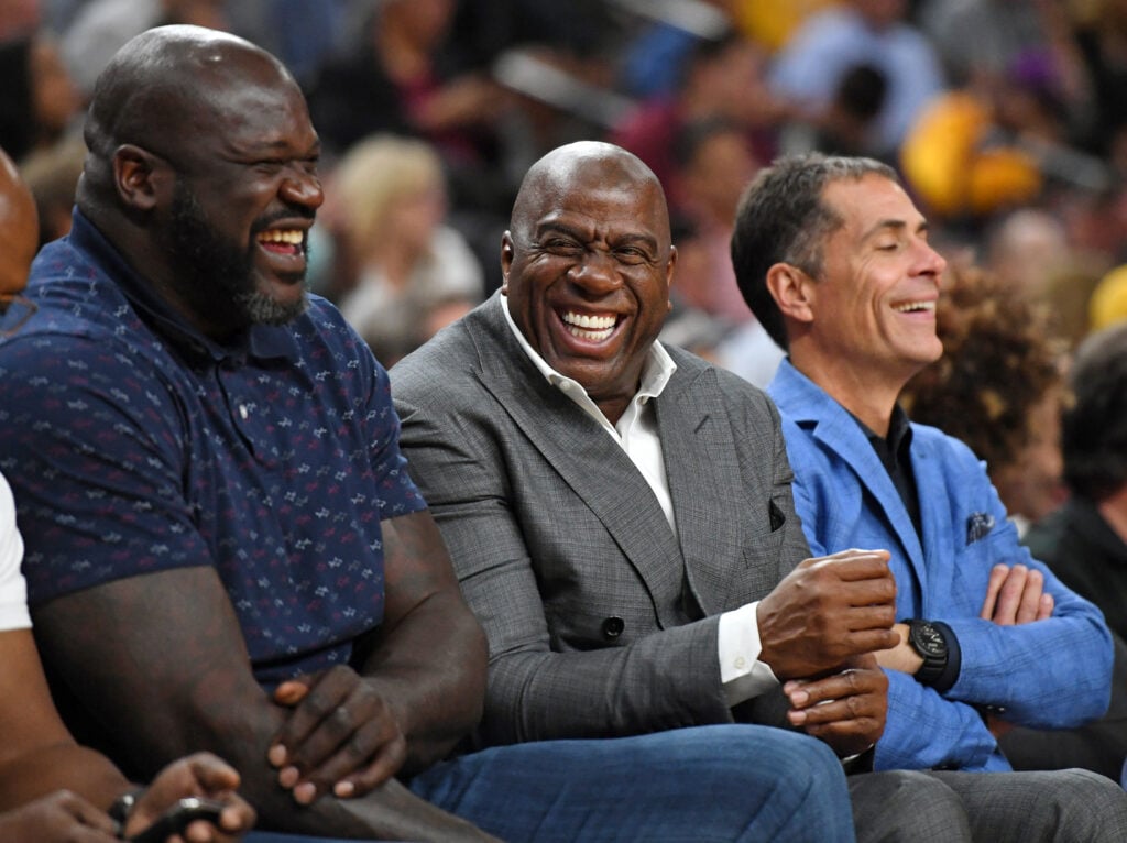 NBA analyst Shaquille O'Neal, Los Angeles Lakers president of basketball operations Earvin "Magic" Johnson and Lakers general manager Rob Pelinka share a laugh during the Lakers' preseason game.