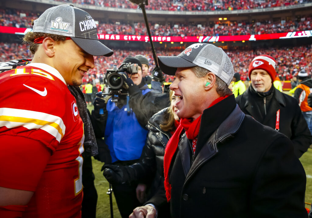 Clark Hunt, CEO and chairman of the Kansas City Chiefs, greets Patrick Mahomes #15 of the Kansas City Chiefs on the football field during the celebration of the team's victory over the Tennessee Titans in the AFC Championship game at Arrowhead Stadium.