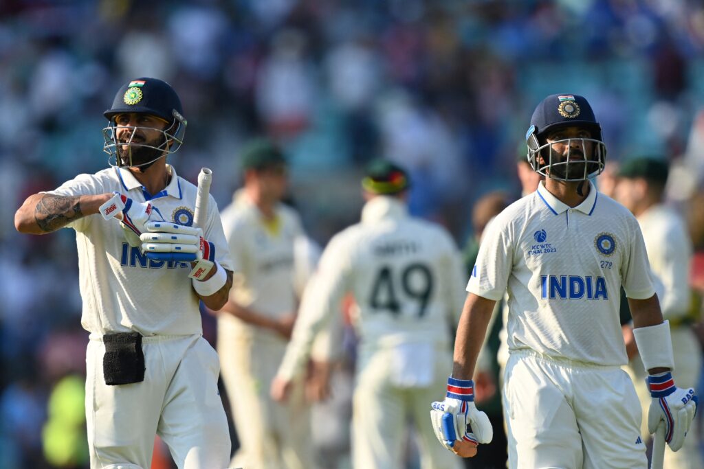 India's Virat Kohli (L) and teammate India's Ajinkya Rahane walk off the field at stumps on day 4 of the ICC World Test Championship cricket final match between Australia and India.