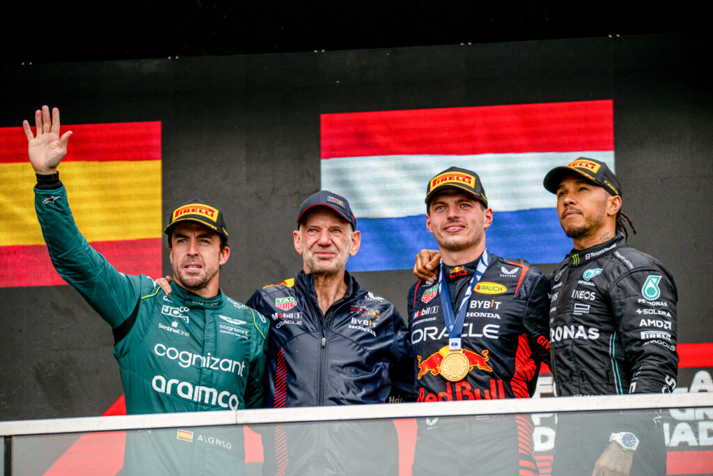 Fernando Alonso, Adrian Newey, Max Verstappen and Lewis Hamilton stand on the podium at the 2023 Canadian Grand Prix