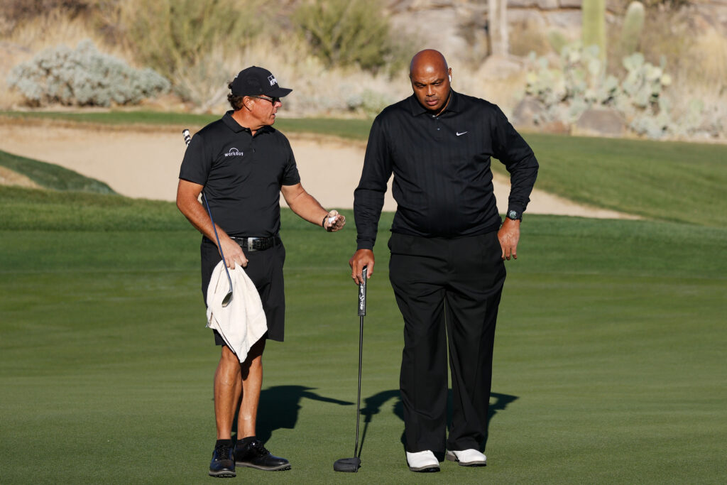 Phil Mickelson and Charles Barkley talk on the eighth green during Capital One's The Match: Champions For Change at Stone Canyon Golf Club