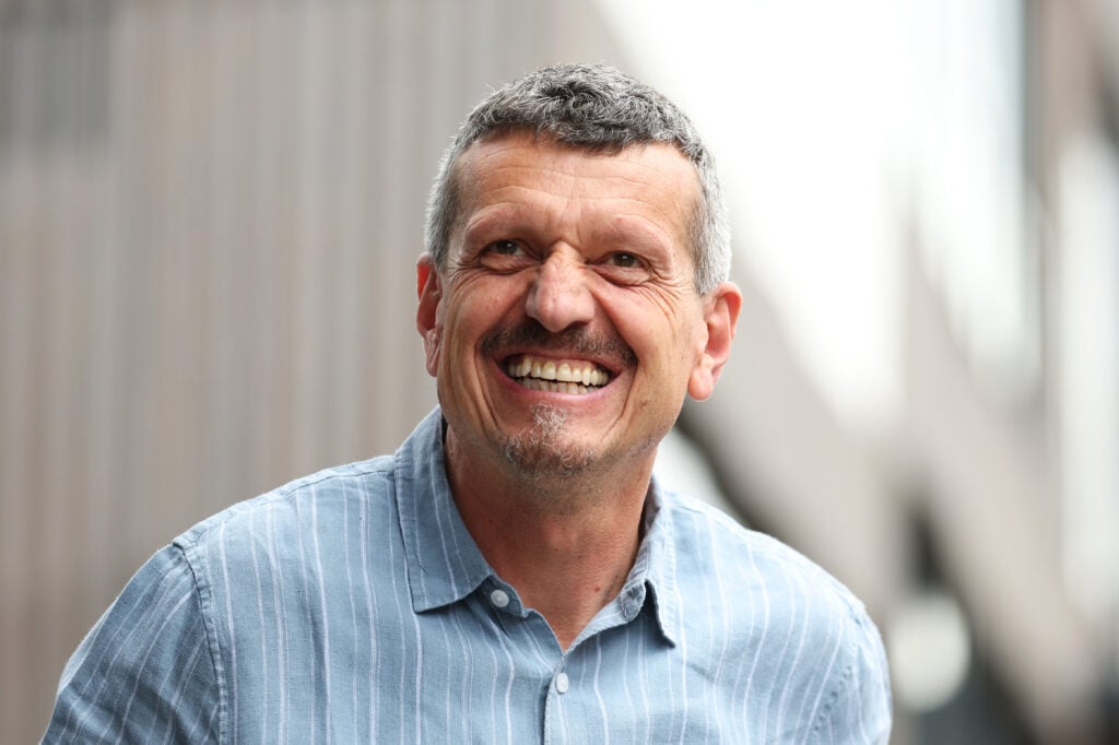 Guenther Steiner, Haas team principal, smiles at the camera as he walks through the paddock ahead of the 2022 Austrian Grand Prix