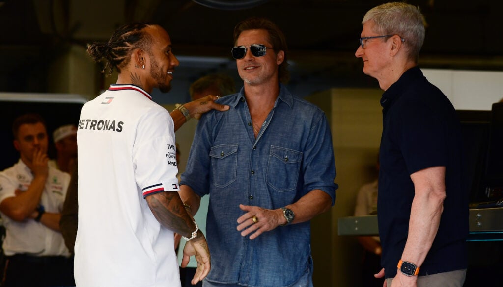 Lewis Hamilton speaking to Hollywood star Brad Pitt and Apple CEO Tim Cook inside the Mercedes garages at the 2022 United States Grand Prix.