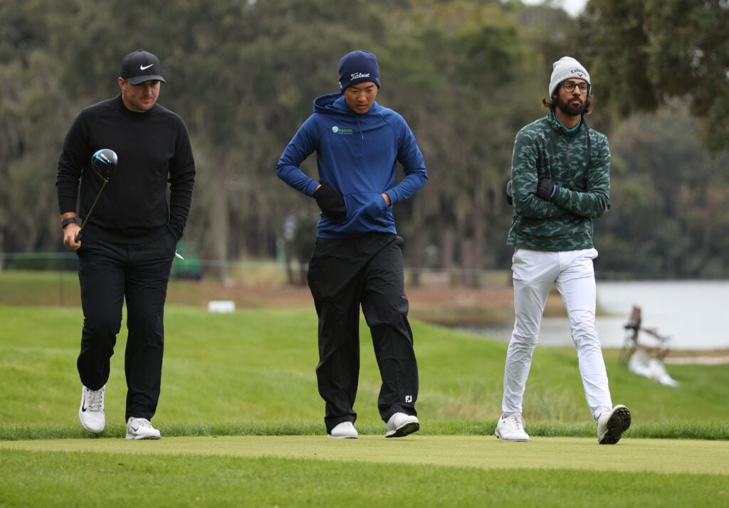 Akshay Bhatia of the United States, Chris Gotterup of the United States and Michael Kim of the United States walk on the course at Sea Island Resort Seaside Course on November 20, 2022 in St Simons Island, Georgia.