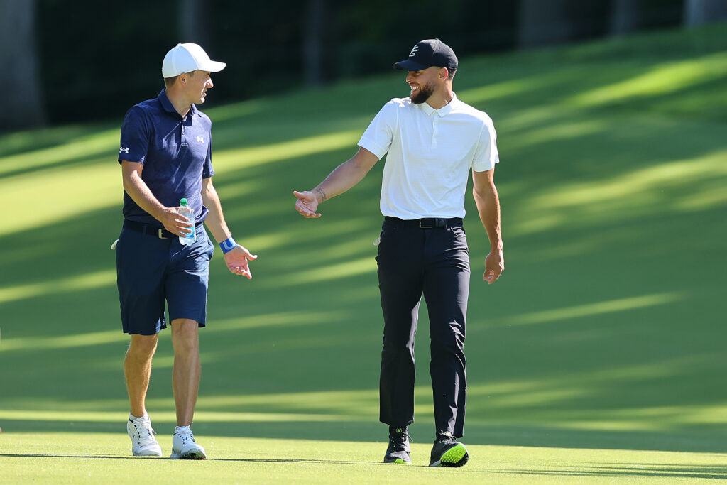 Jordan Spieth of the United States laughs with Stephen Curry of the Golden State Warriors.