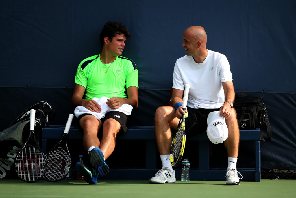 Milos Raonic of Cananda speaks with Ivan Ljubicic during a practice session on Day Five of the 2013 US Open at USTA Billie Jean King National Tennis Center on August 30, 2013 in the Flushing neighborhood of the Queens borough of New York City.