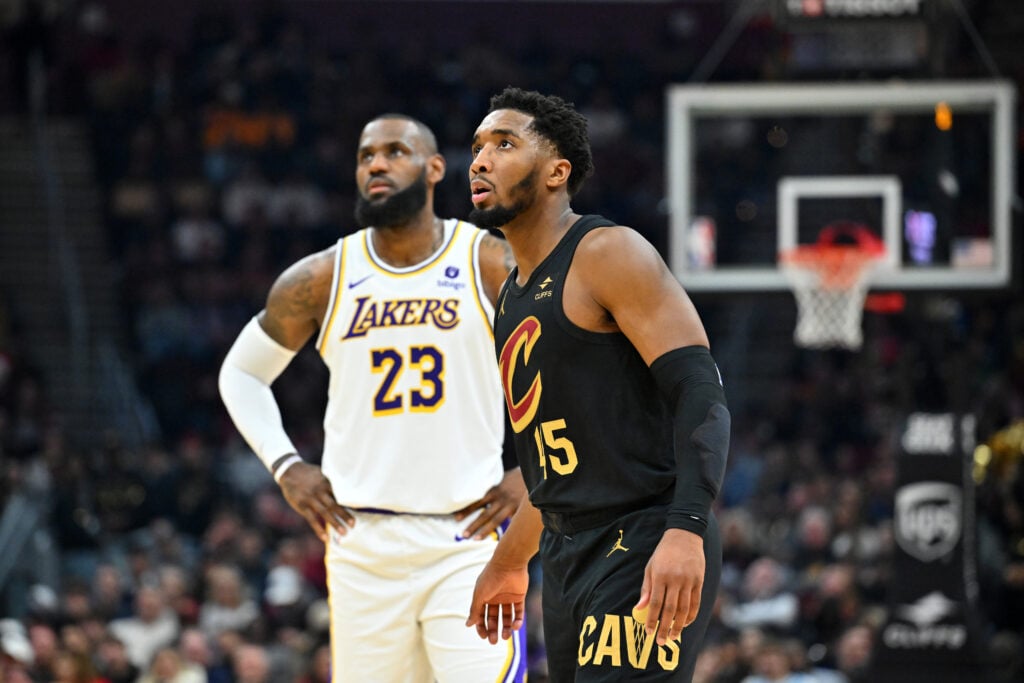 Donovan Mitchell #45 of the Cleveland Cavaliers and LeBron James #23 of the Los Angeles Lakers wait for a free throw during the first quarter at Rocket Mortgage Fieldhouse on November 25, 2023 in Cleveland, Ohio.