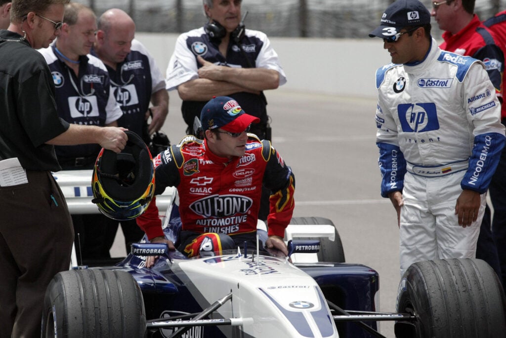 Jeff Gordon sitting on Juan Pablo Montoya's Williams car