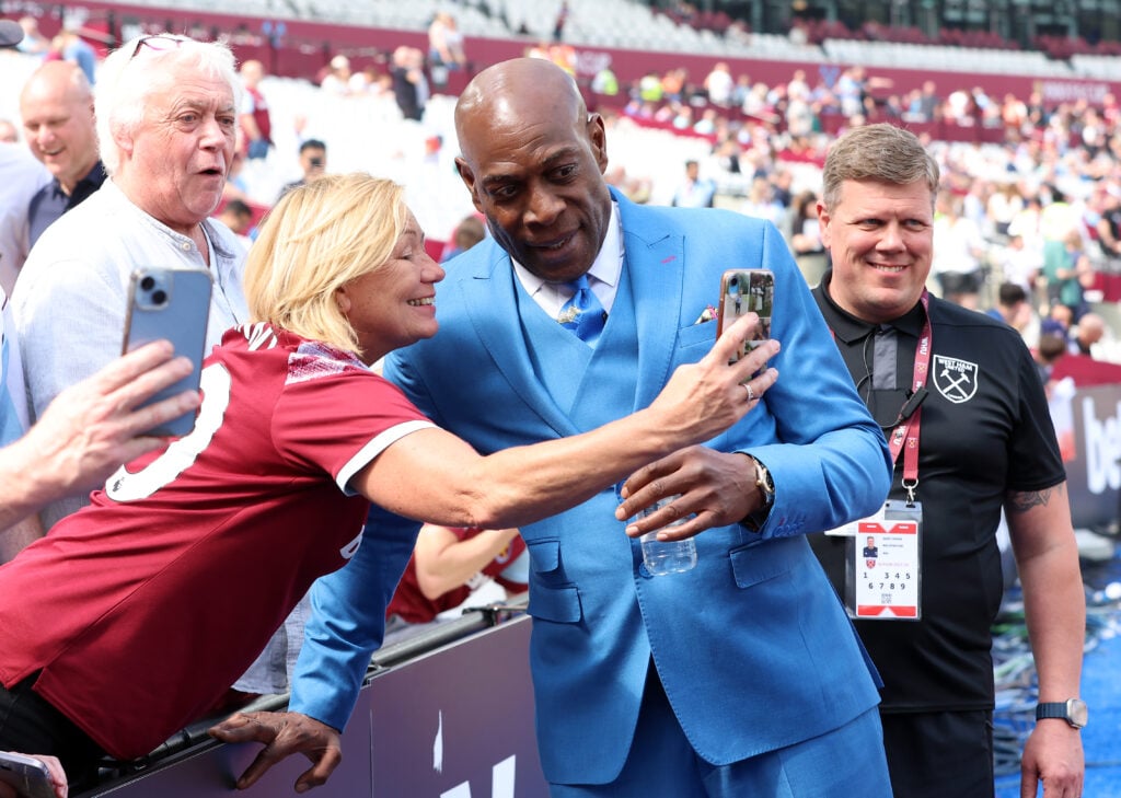 Former British Professional Boxer Frank Bruno poses for a photo with a fan during the Premier League match between West Ham United and Luton Town at London Stadium.