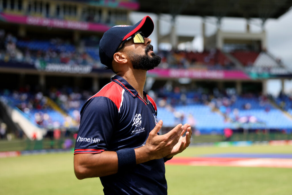 Ali Khan of USA walks out in to the field.