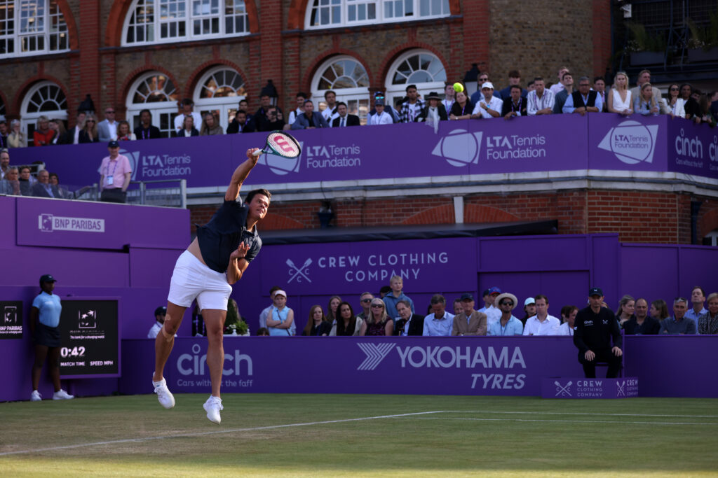 Milos Raonic serves against Taylor Fritz at the 2024 Queen's Club Championships.