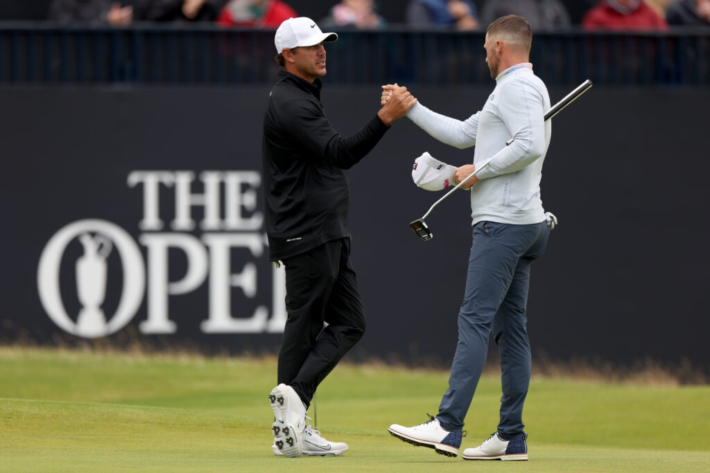 Brooks Koepka of the United States and Wyndham Clark of the United States shake hands on the 18th green during day two of The 152nd Open championship at Royal Troon on July 19, 2024.