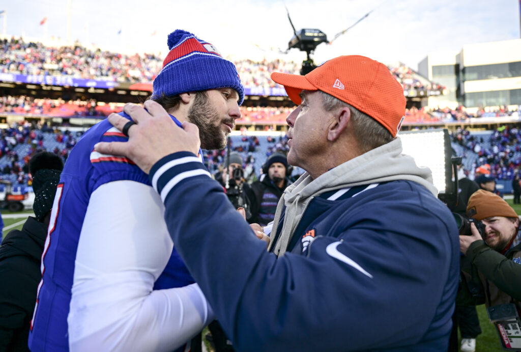 Josh Allen (17) of the Buffalo Bills embraces Denver Broncos head coach Sean Payton after the fourth quarter of the Bills' 31-7 AFC divisional playoff win.