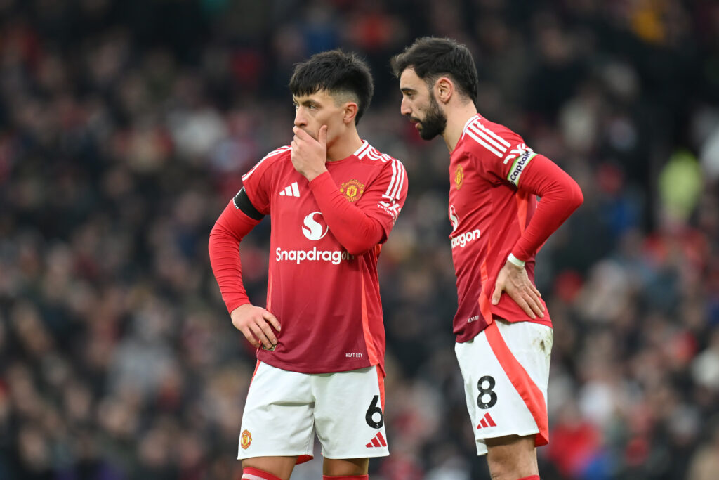Lisandro Martinez and Bruno Fernandes of Manchester United look on during the Premier League match between Manchester United FC and Crystal Palace FC at Old Trafford on February 02, 2025 in Manchester, England.
