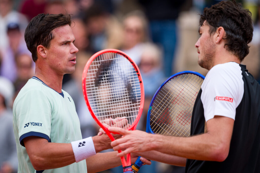 Daniel Altmaier (L) of Germany shakes hands with Taylor Fritz of the United States after victory during the Men's Singles First Round match on Day Two of the 2025 French Open at Roland Garros on May 26, 2025 in Paris, France.