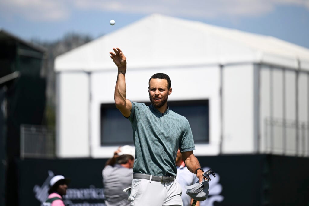 Stephen Curry throws his ball to fans after sinking the 18th hole during the second round of the American Century Championship at Edgewood Tahoe Golf Course.