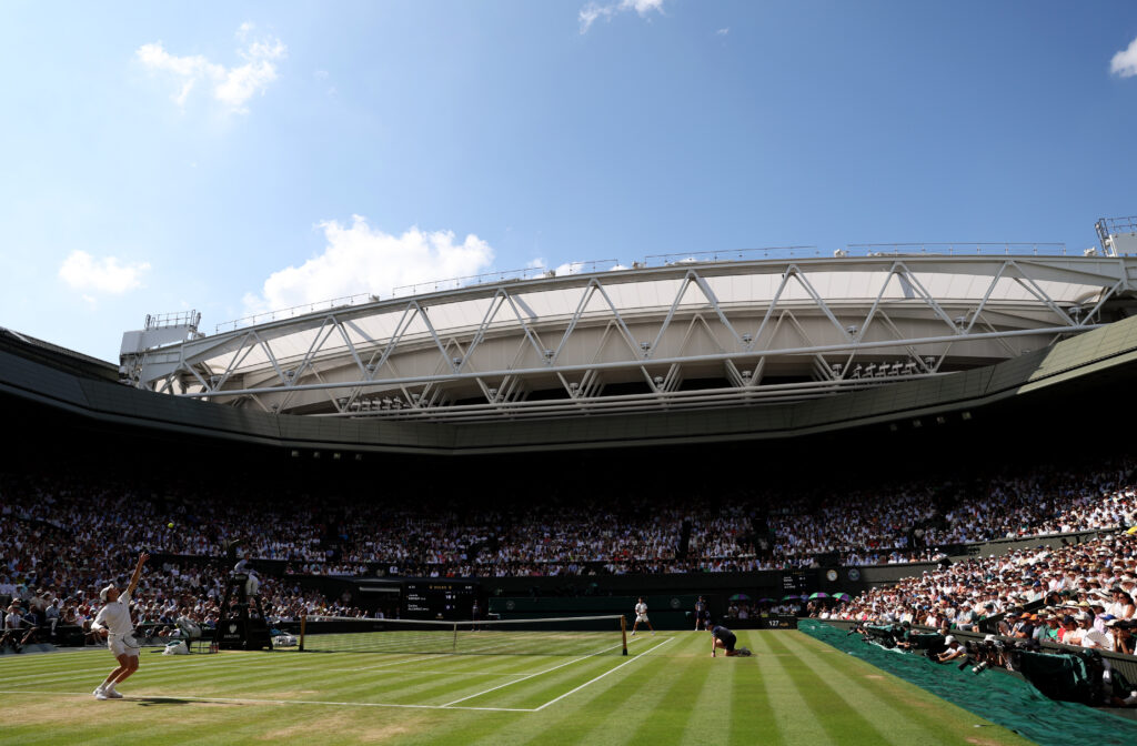 A general view over Centre Court as Jannik Sinner of Italy serves against Carlos Alcaraz of Spain during the Gentleman's Singles Final on day fourteen of The Championships Wimbledon 2025 at All England Lawn Tennis and Croquet Club.