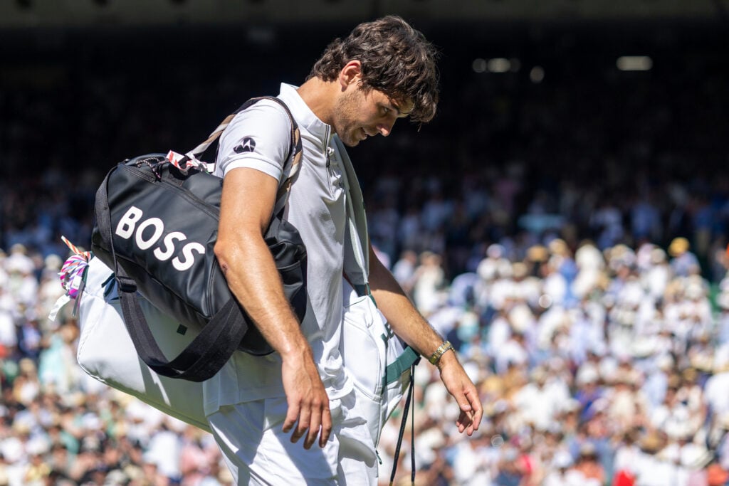 Taylor Fritz walks off court after losing to Carlos Alcaraz at Wimbledon in 2025