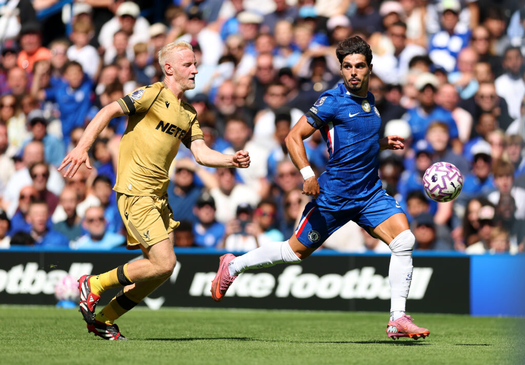 Pedro Neto of Chelsea is challenged by Will Hughes of Crystal Palace during the Premier League match between Chelsea and Crystal Palace.