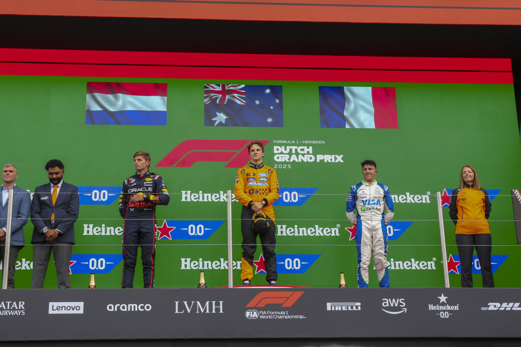 Max Verstappen, Oscar Piastri, and Isack Hadjar stand on the podium during the Formula 1 Heineken Dutch Grand Prix 2025.