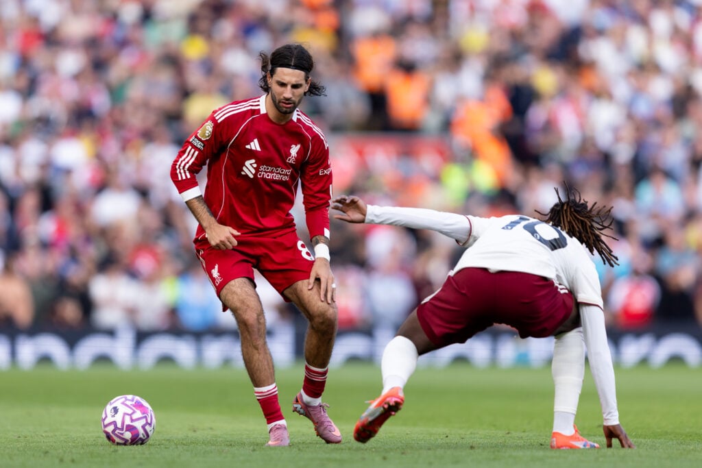 Dominik Szoboszlai of Liverpool faces Eberechi Eze of Arsenal during the Premier League match between Liverpool and Arsenal at Anfield on August 31, 2025 in Liverpool, England.