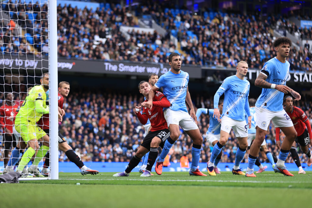 Manuel Ugarte of Manchester United tussles with Rodri of Manchester City during the Premier League match between Manchester City and Manchester United at Etihad Stadium on September 14, 2025.