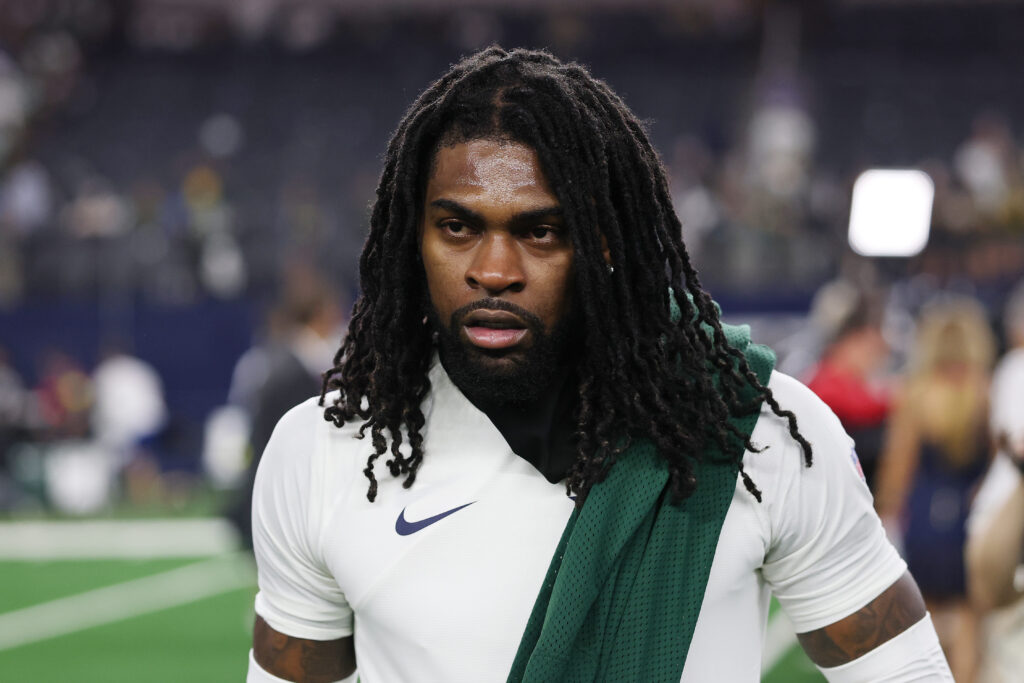 Trevon Diggs #7 of the Dallas Cowboys leaves the field with a Micah Parsons #1 of the Green Bay Packers jersey after a tie game at AT&T Stadium.