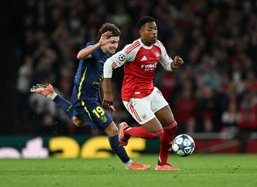 Myles Lewis-Skelly of Arsenal takes on Julian Alvarez of Atletico during the UEFA Champions League 2025/26 League Phase MD3 match between Arsenal FC and Atletico de Madrid at Arsenal Stadium on October 21, 2025 in London, England.