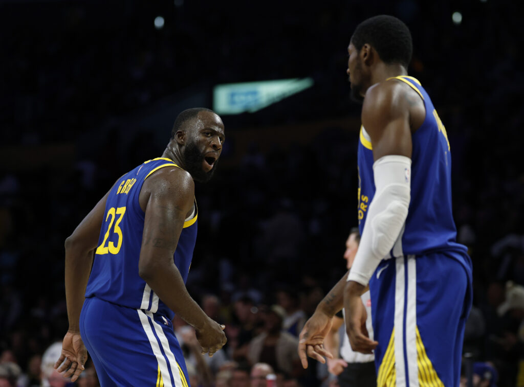 Draymond Green #23 of the Golden State Warriors reacts to Jonathan Kuminga #1 during a 119-109 Warriors win in the season opening game between the Golden State Warriors and the Los Angeles Lakers at Crypto.com Arena.