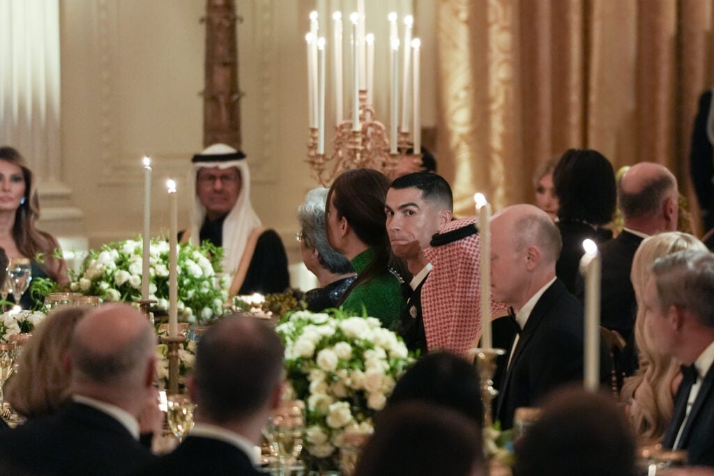 Portuguese soccer star Cristiano Ronaldo listens as President Donald Trump speaks at a dinner with Saudi Crown Prince Mohammed bin Salman.