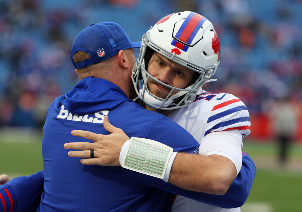 Buffalo Bills offensive coordinator Joe Brady and Josh Allen #17 of the Buffalo Bills embrace before a game against the Tampa Bay Buccaneers.