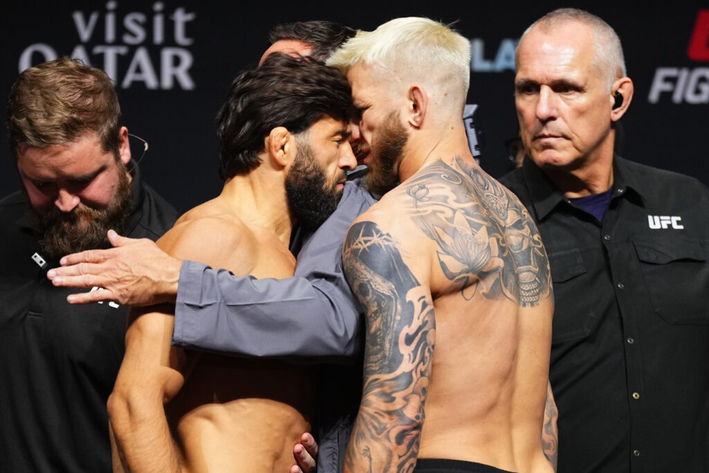 Arman Tsarukyan of Georgia headbutts opponent Dan Hooker of New Zealand during the UFC Fight Night ceremonial weigh-in at ABHA Arena on November 21, 2025 in Doha, Qatar.