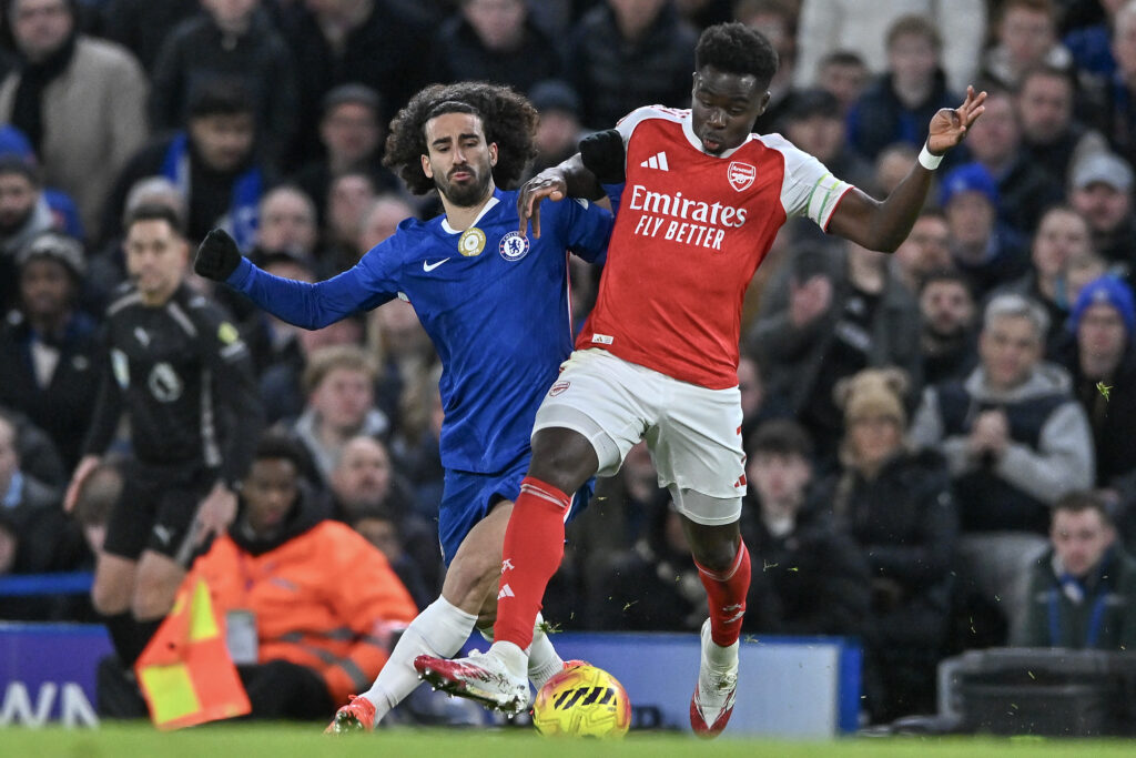 Bukayo Saka of Arsenal battles with Marc Cucurella of Chelsea during the Premier League match between Chelsea and Arsenal at Stamford Bridge on November 30, 2025 in London, England.