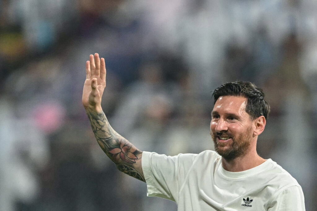 Argentina's footballer Lionel Messi greets fans during his GOAT Tour at the Wankhede Stadium in Mumbai.