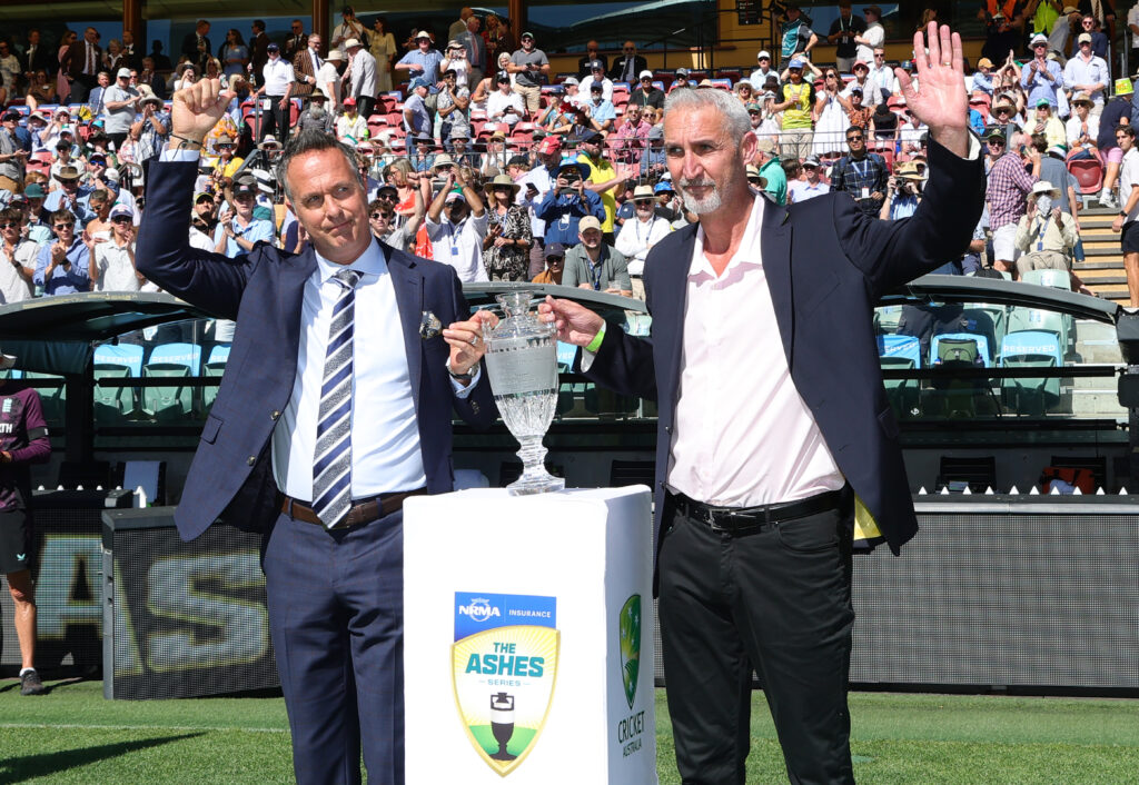 Michael Vaughan former English cricketer and former Australian cricketer Jason Gillespie walk out with the Ashes Crystal replica urn during day one of the Third Test Match in the 2025-26 Ashes Series between Australia and England