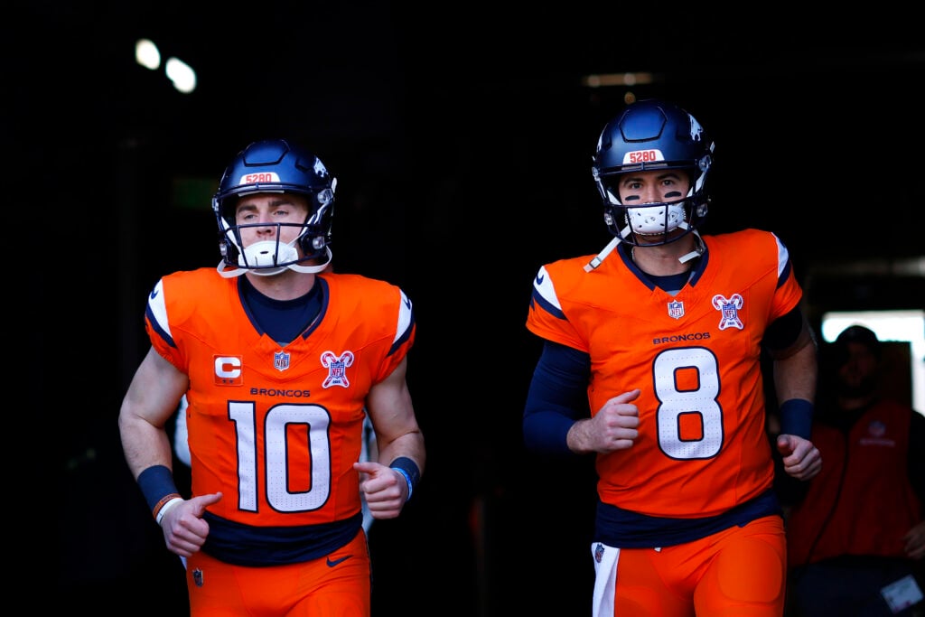 Jarrett Stidham #8 and Bo Nix #10 of the Denver Broncos take the field prior to a game against the Jacksonville Jaguars at Empower Field.