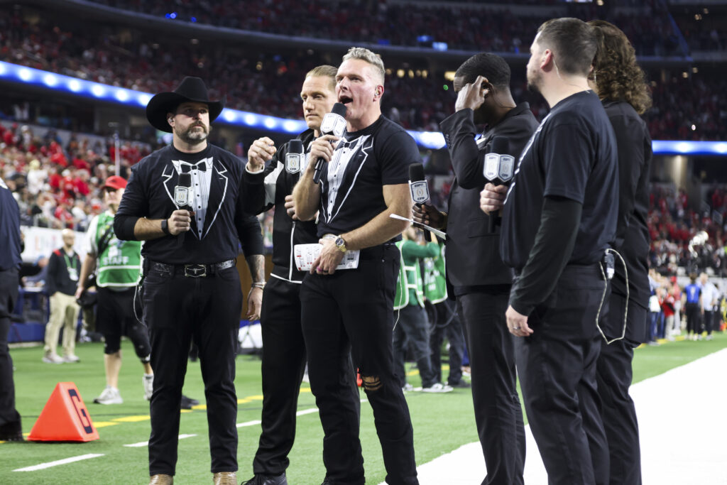 Members of The Pat McAfee Show commentate on the game from the sidelines in the first half during the College Football Playoff Quarter Final Game between the Miami Hurricanes and the Ohio State Buckeyes.