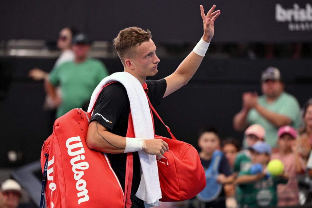 Jiri Lehecka waves to the crowd after retiring from his match against Sebastian Korda at the 2026 Brisbane International.