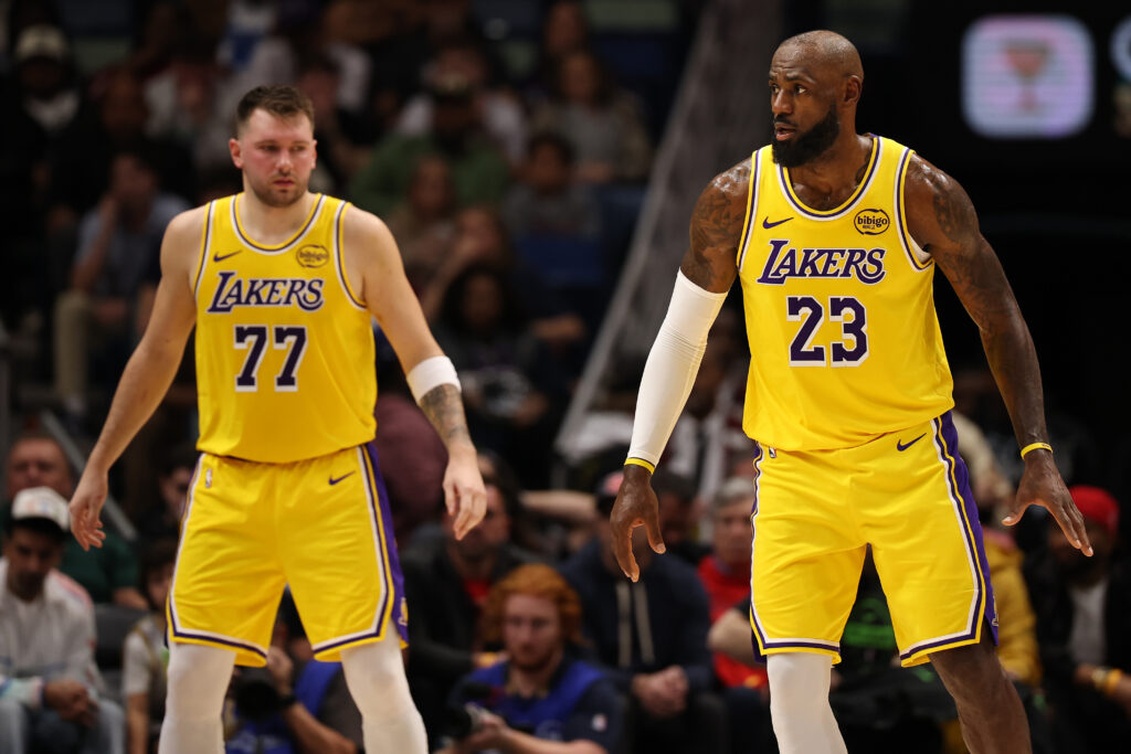 LeBron James #23 of the Los Angeles Lakers and Luka Doncic #77 of the Los Angeles Lakers look on during the game against the New Orleans Pelicans at Smoothie King Center.
