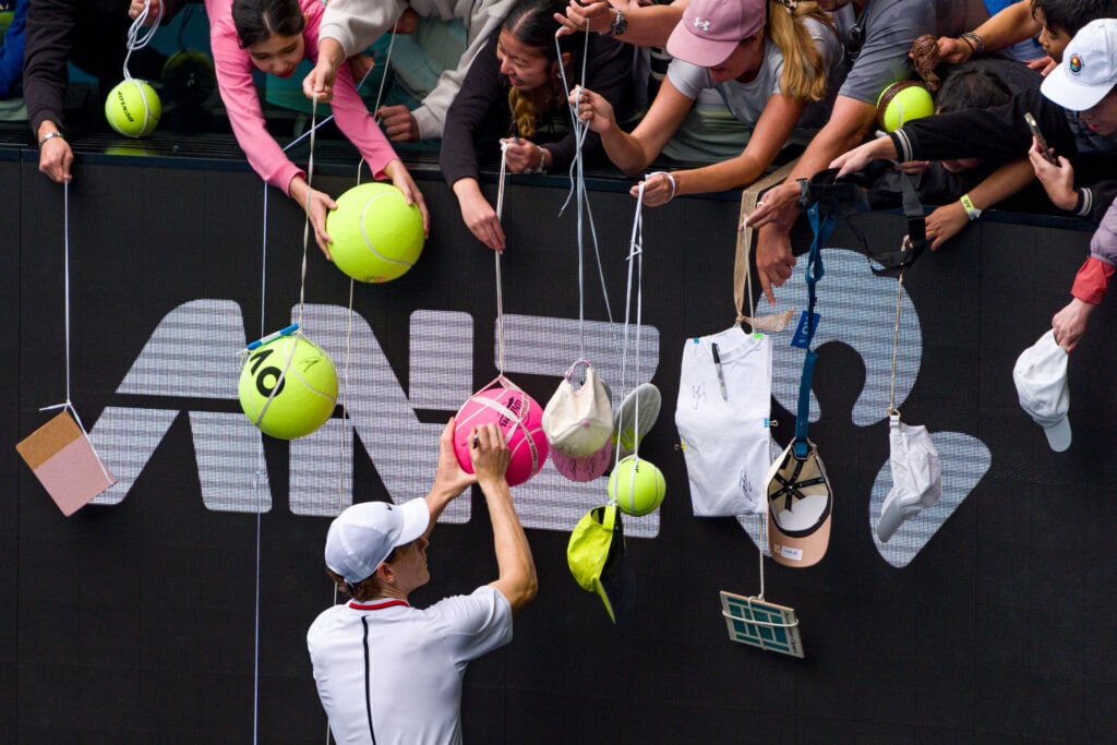 Jannik Sinner of Italy signs autographs for fans during a practice session ahead of the 2026 Australian Open at Melbourne Park on January 13, 2026.