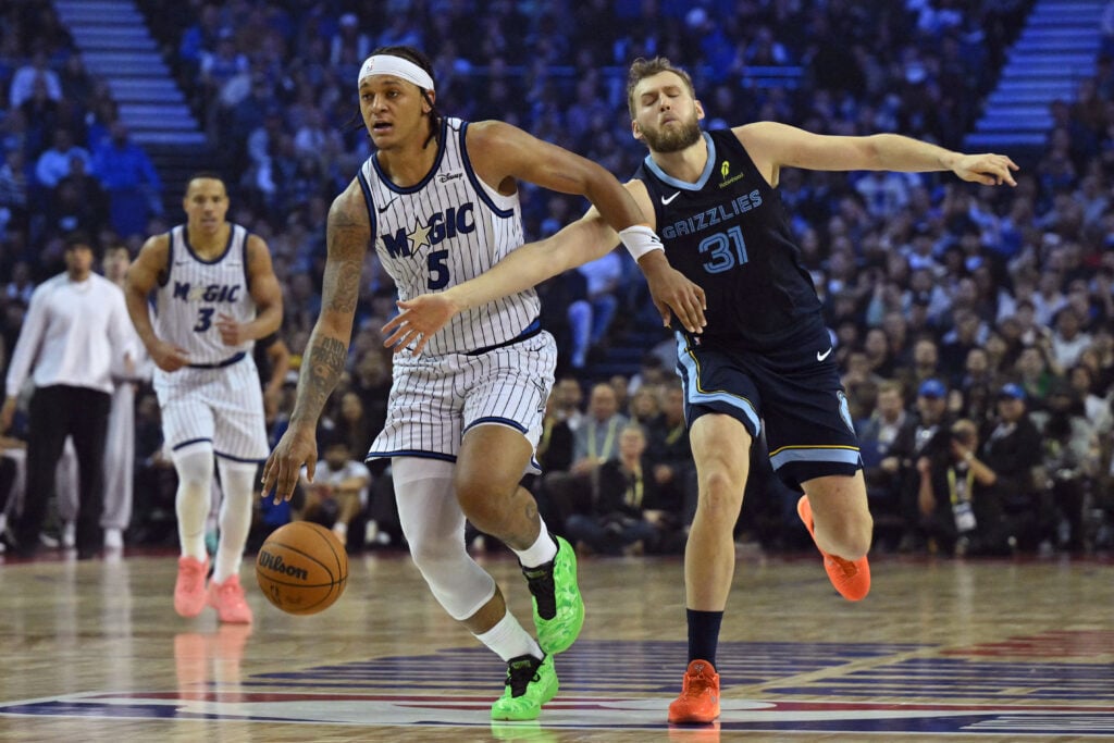 Orlando Magic's US power forward #05 Paolo Banchero (L) dribbles past Memphis Grizzlies' Australian center #31 Jock Landale (R) during the 2025/2026 NBA season basketball match between the Memphis Grizzlies and Orlando Magic
