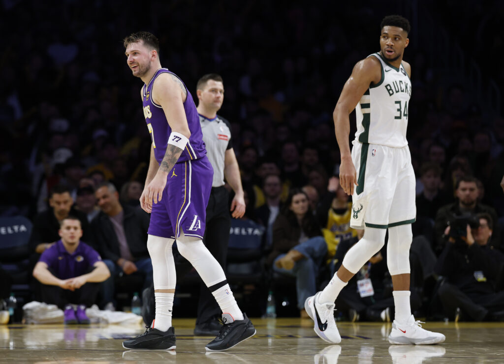 Luka Doncic #77 of the Los Angeles Lakers reacts with Giannis Antetokounmpo #34 of the Milwaukee Bucks during a 105-101 Bucks win at Crypto.com Arena on January 09, 2026.