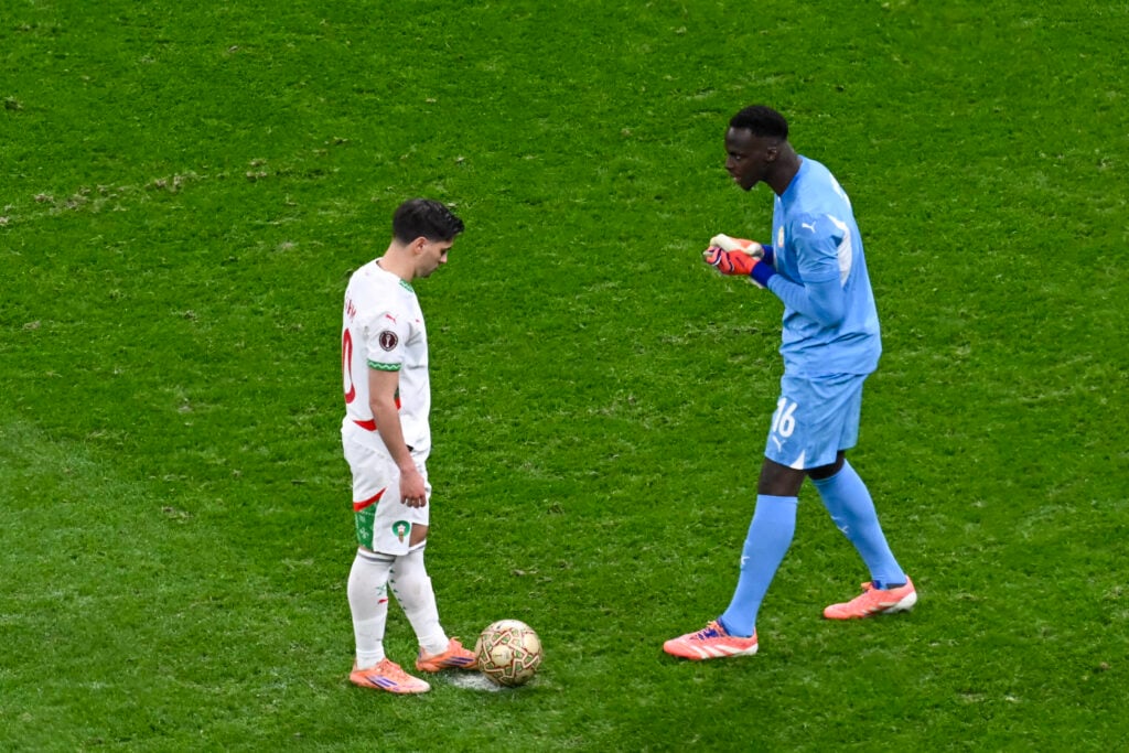Senegal's goalkeeper #16 Edouard Mendy speaks to Morocco's forward #10 Brahim Diaz before a penalty kick during the Africa Cup of Nations (CAN) final football match between Senegal and Morocco at the Prince Moulay Abdellah Stadium.