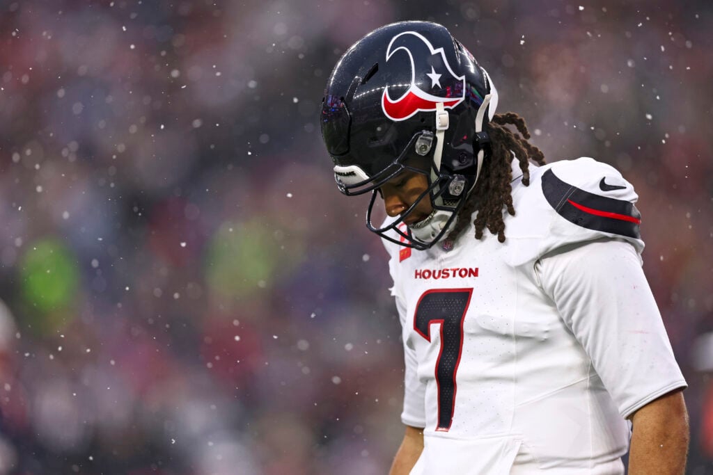 C.J. Stroud #7 of the Houston Texans reacts after an interception was returned for a touchdown during the second quarter of an NFL divisional playoff football game against the New England Patriots at Gillette Stadium on January 18, 2026 in Foxborough, Massachusetts.