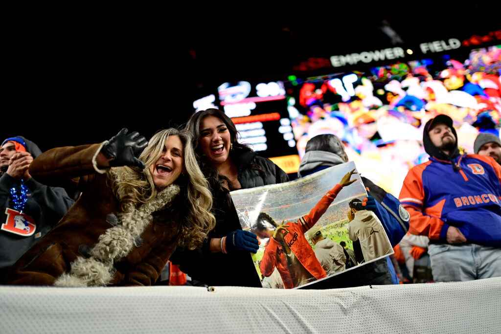 A Denver Broncos fan holding a photo of the wife of Buffalo Bills quarterback Josh Allen (17), Hailee Steinfeld, supporting the Denver Broncos in the 2016 Super Bowl during the AFC Divisional Round game between the Denver Broncos and the Buffalo Bills at Empower Field at Mile High.