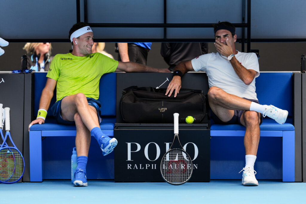 Casper Ruud and Roger Federer sitting down at the Australian Open.