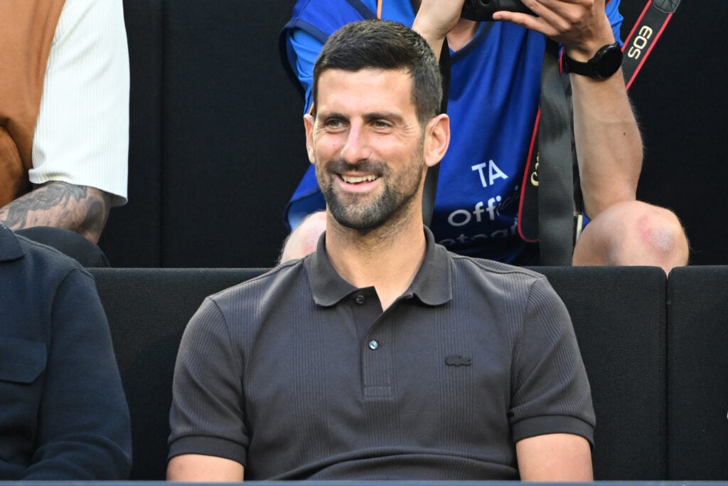 Novak Djokovic watches the Opening Ceremony exhibition ahead of the 2026 Australian Open.
