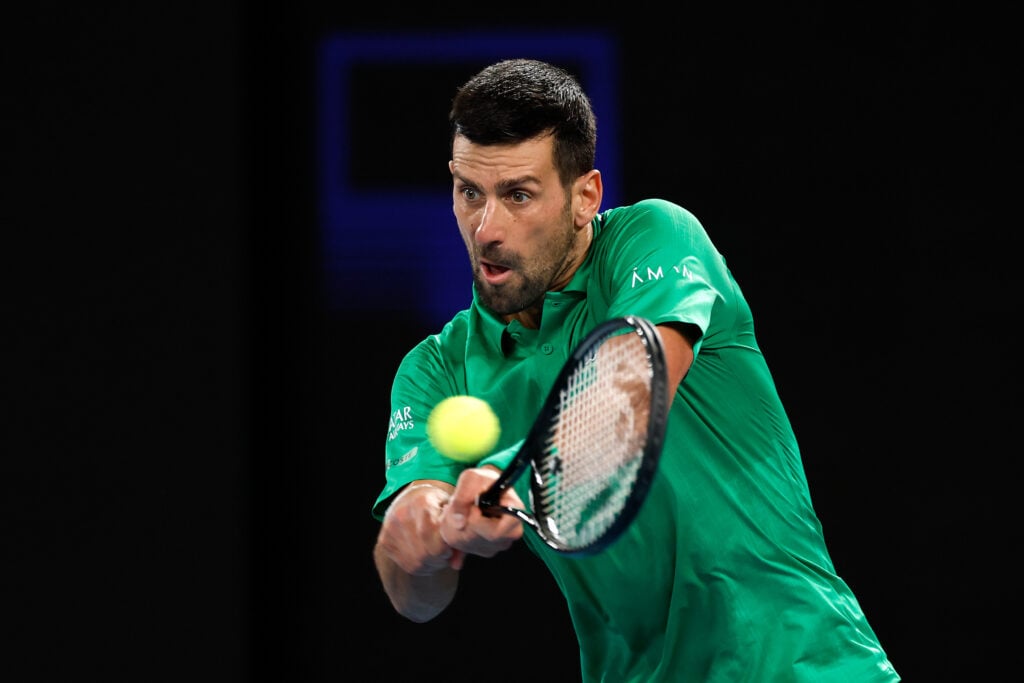 Novak Djokovic of Serbia plays a backhand against Pedro Martinez of Spain during the Men's Singles First Round match on day two of the 2026 Australian Open at Melbourne Park on January 19, 2026 in Melbourne, Australia.